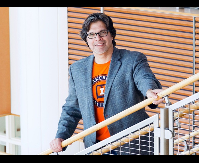 Aric Rindfleisch standing on stairs.