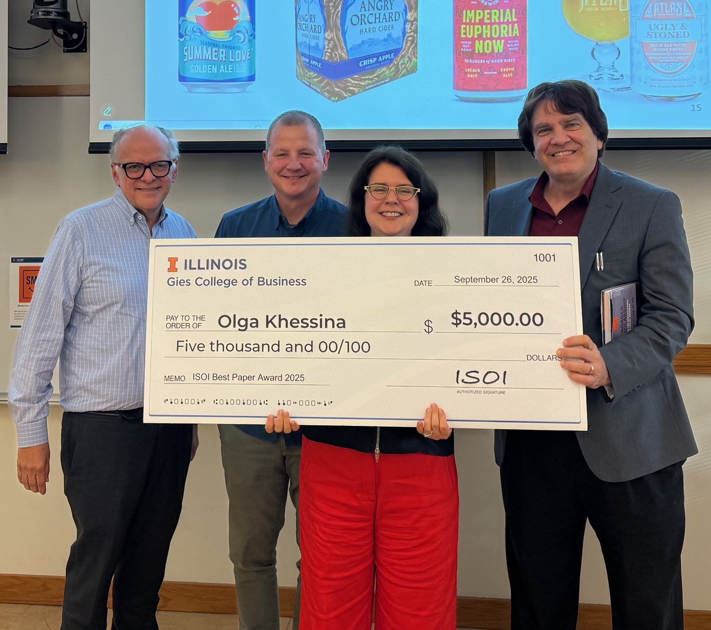 A picture of Olga Khessina receiving a best paper award.