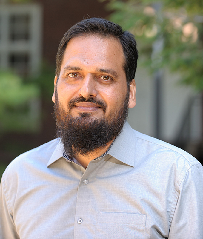 A headshot of Abdul Qadir Shah